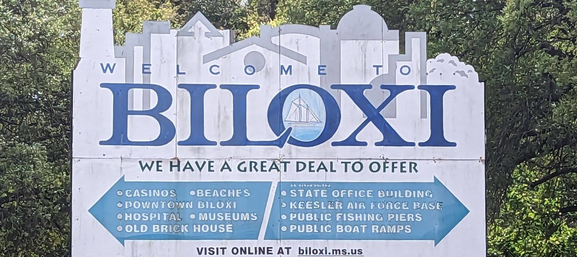 A white and blue sign that says BILOXI We have a Great Deal to Offer